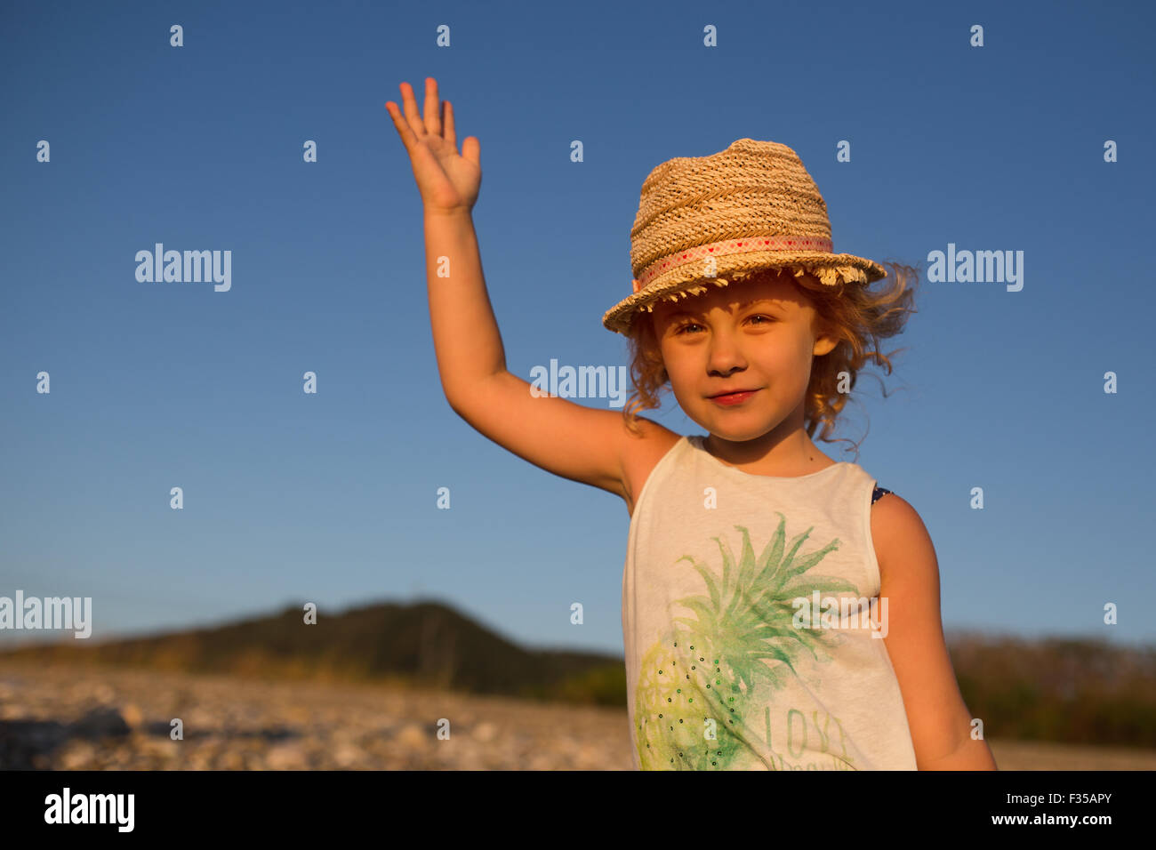 Cute little girl emotional outdoor portrait in warm light of sunset Stock Photo