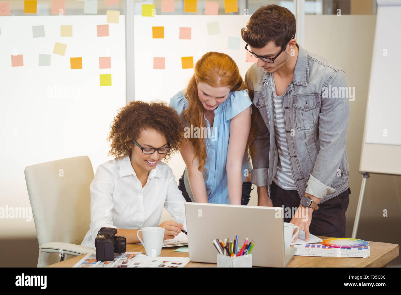 Smiling businesswoman with colleagues Stock Photo