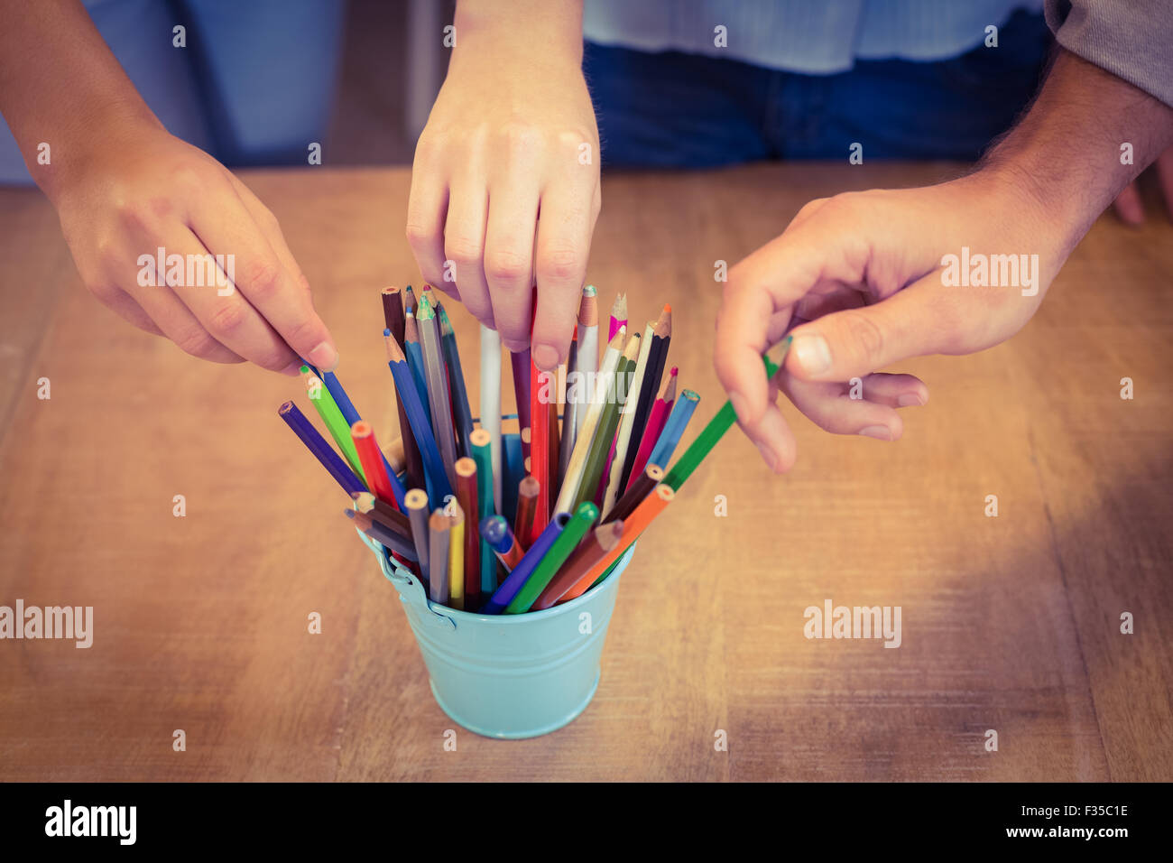 Business people choosing pencils from desk organizer Stock Photo