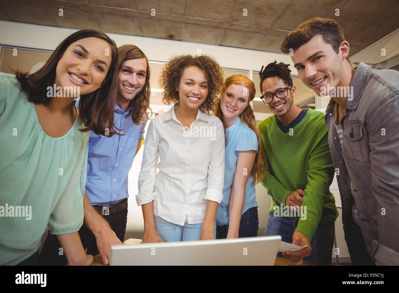 Portrait of smiling business people with laptop Stock Photo - Alamy