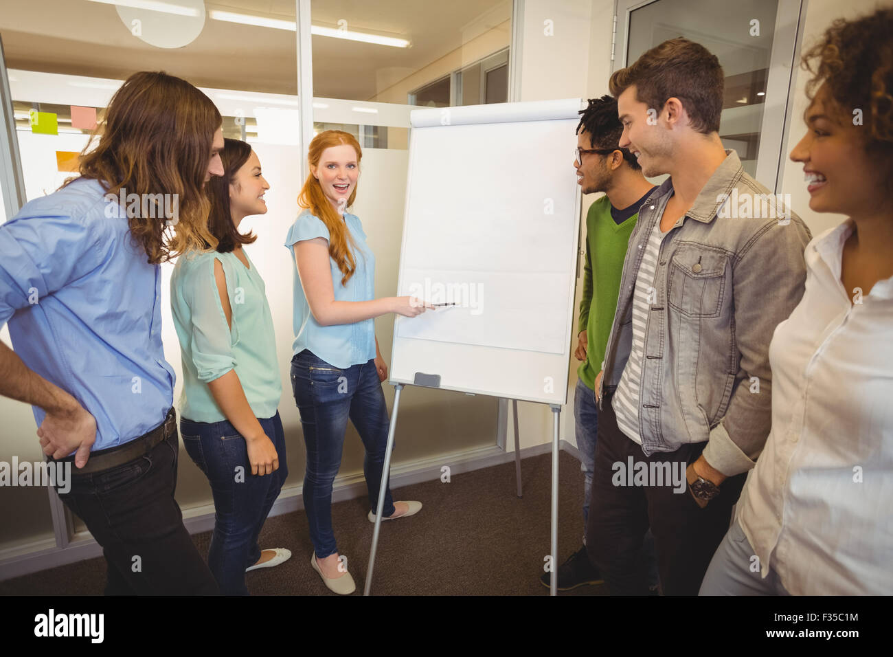 Businesswoman discussing with colleagues in meeting Stock Photo