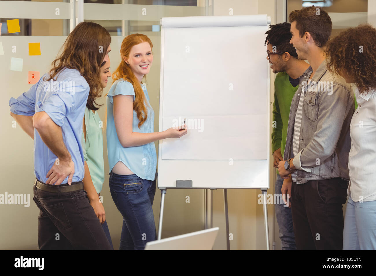 Smiling businesswoman discussing with colleagues Stock Photo