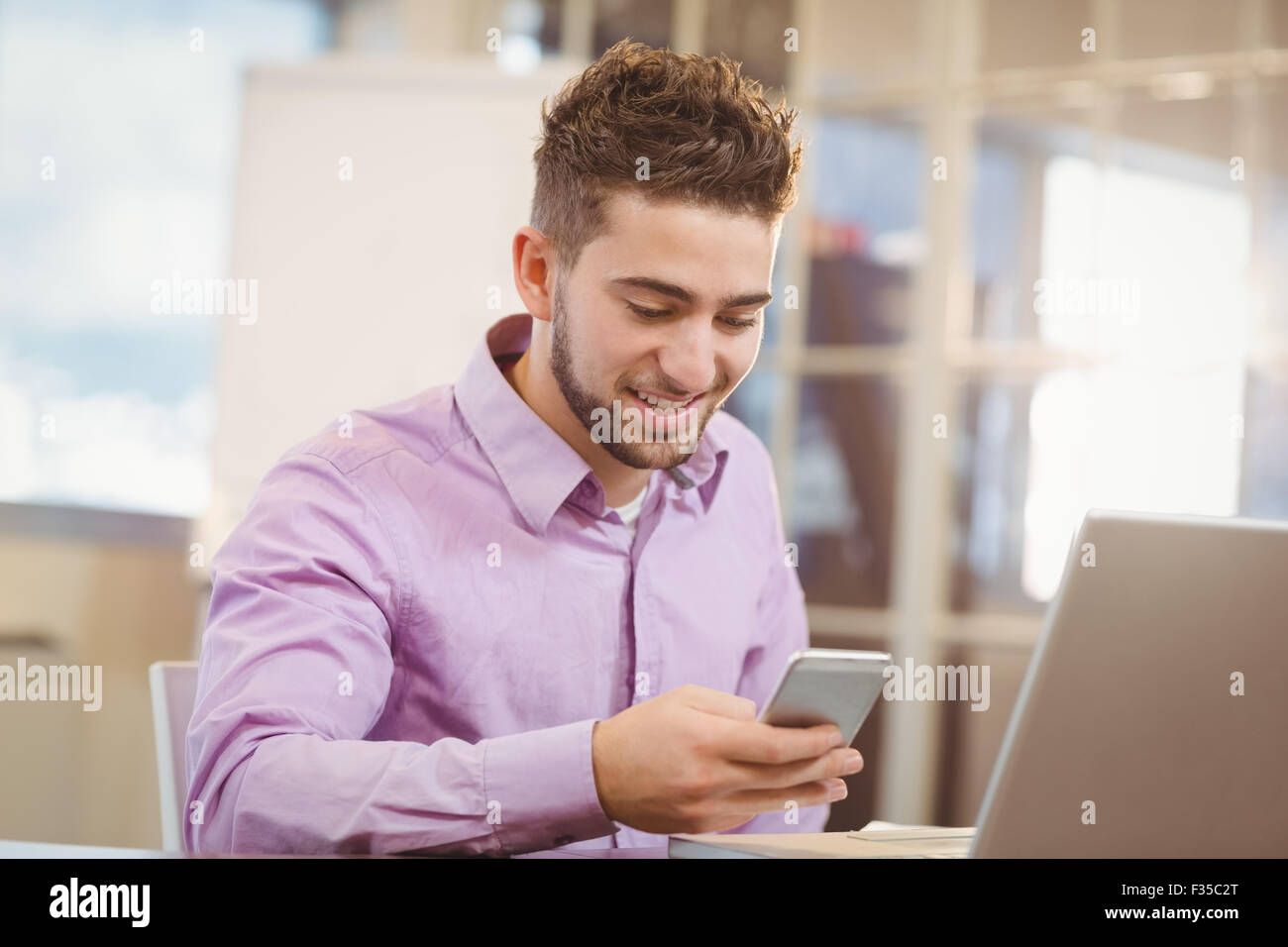 Businessman using smart phone  in office Stock Photo