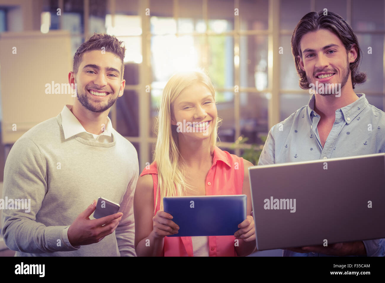 Confident business people working with the help of technologies Stock Photo