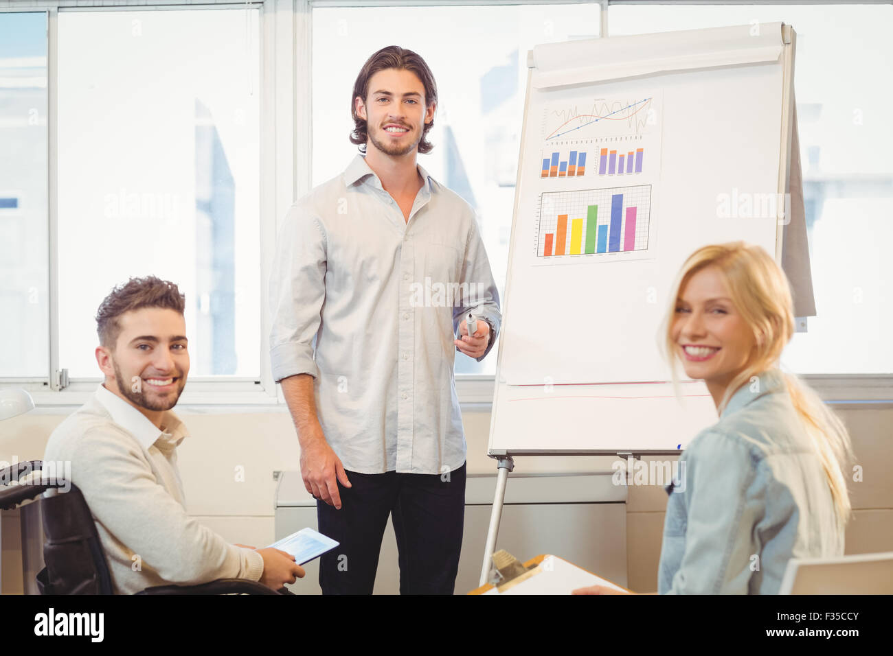 Business people with whiteboard during meeting Stock Photo