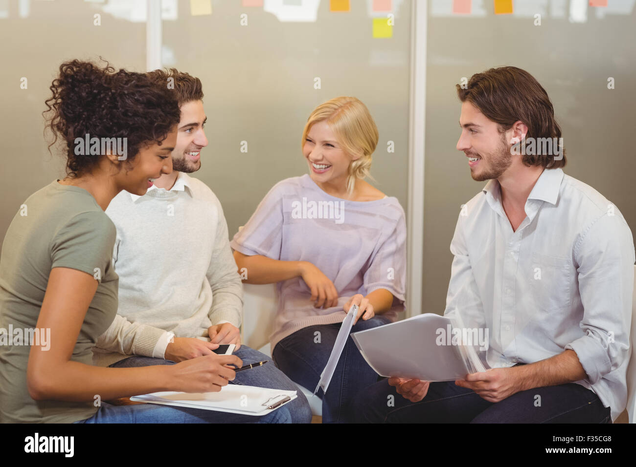 Colleagues interacting with each other Stock Photo