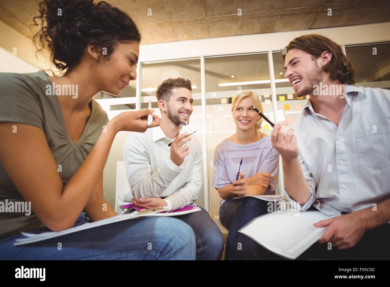 Colleagues interacting with each other Stock Photo