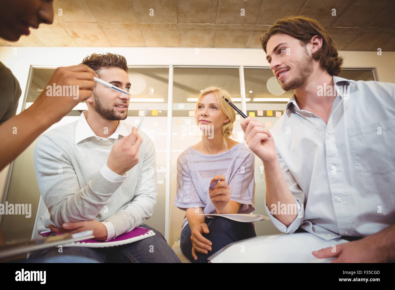 Colleagues interacting with each other Stock Photo
