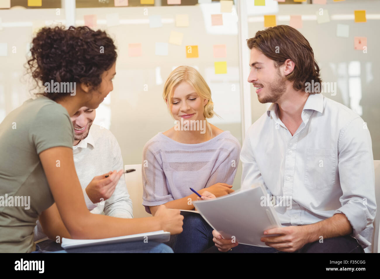 Colleagues interacting with each other Stock Photo
