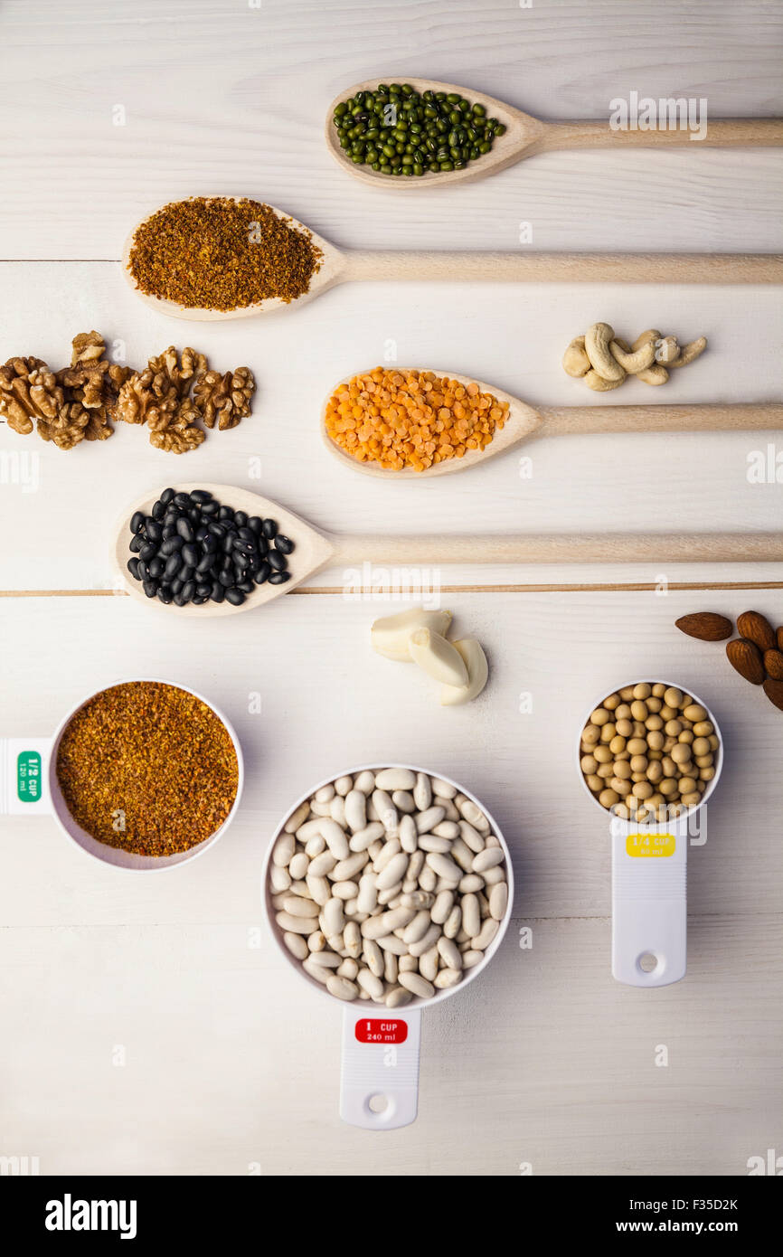 Spoons and cups of pulses and seeds Stock Photo