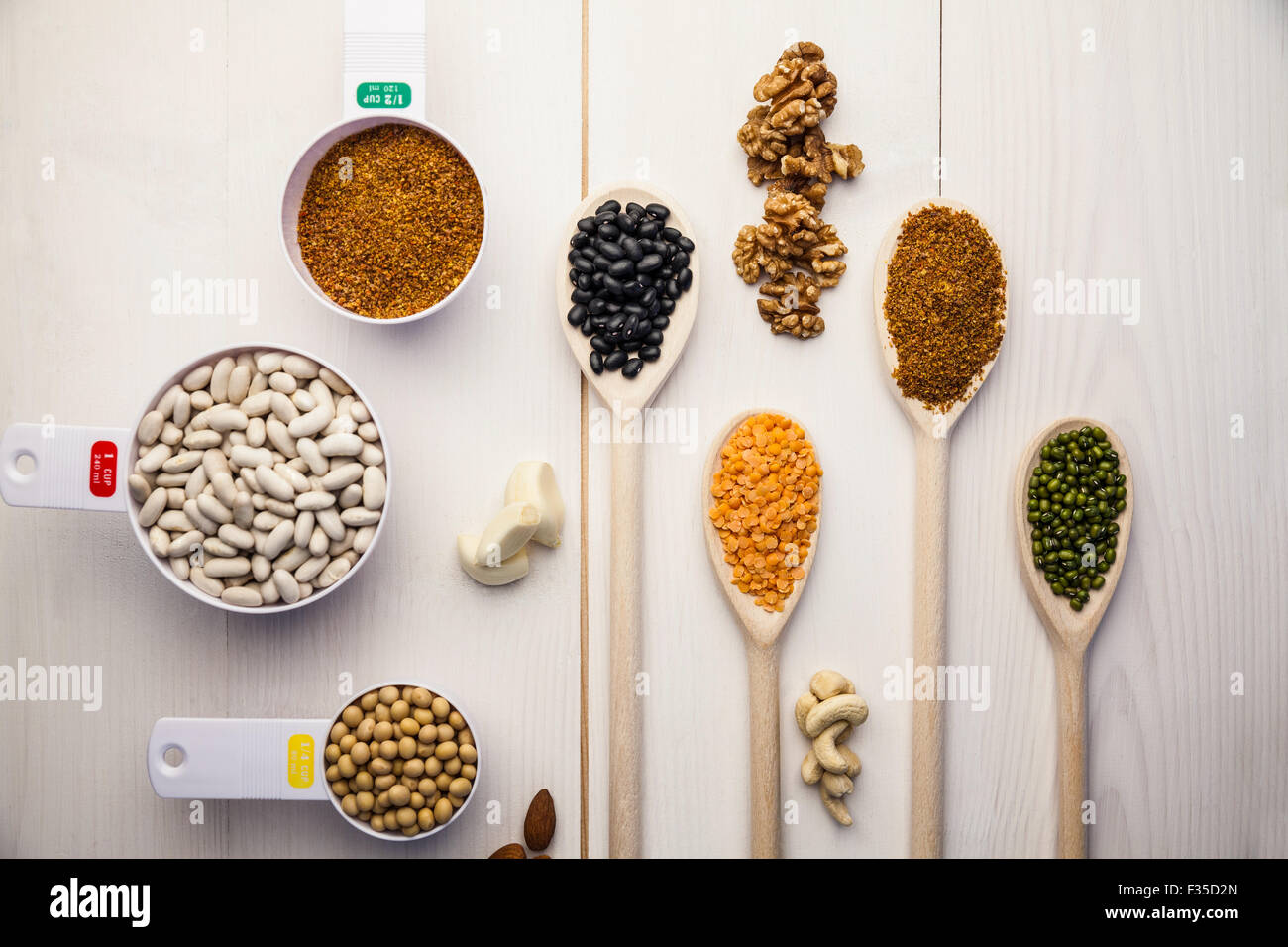 Spoons and cups of pulses and seeds Stock Photo
