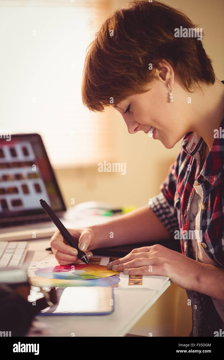 Graphic designer drawing on colour chart Stock Photo