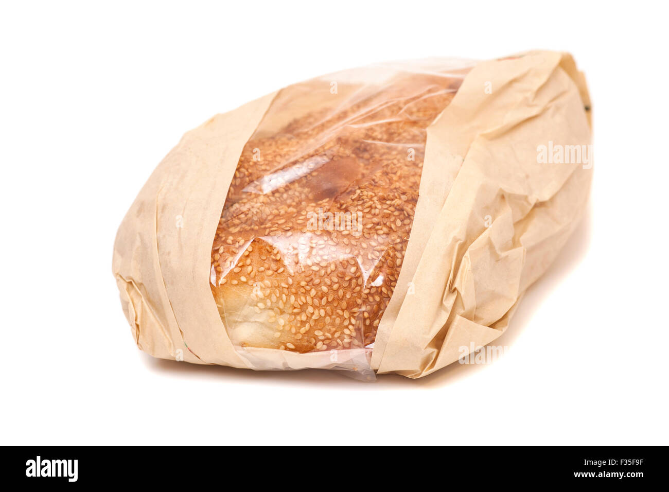 White bread with sesame in a paper bag isolated on white background ...
