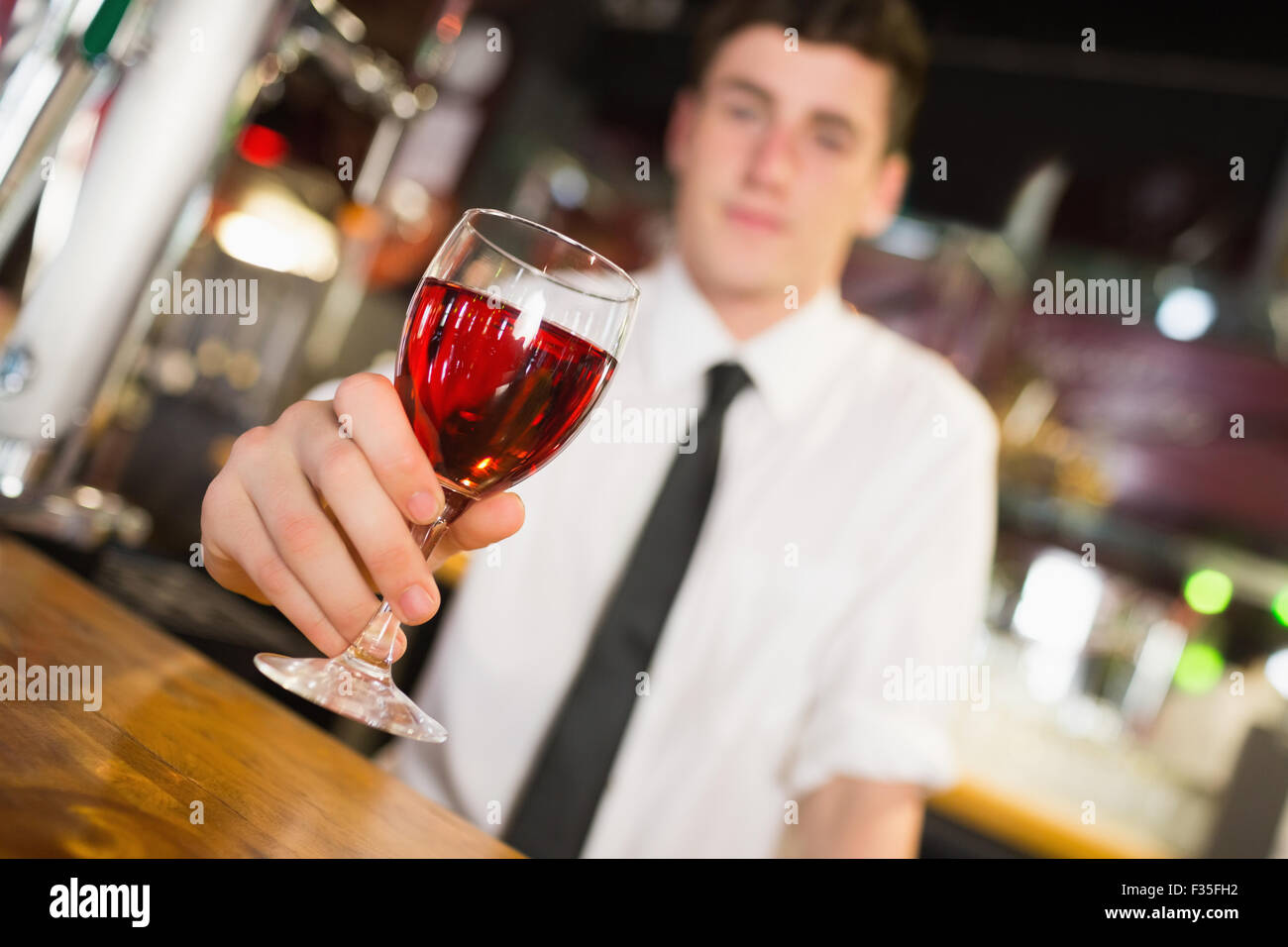 Male barkeepe serving alcohol Stock Photo