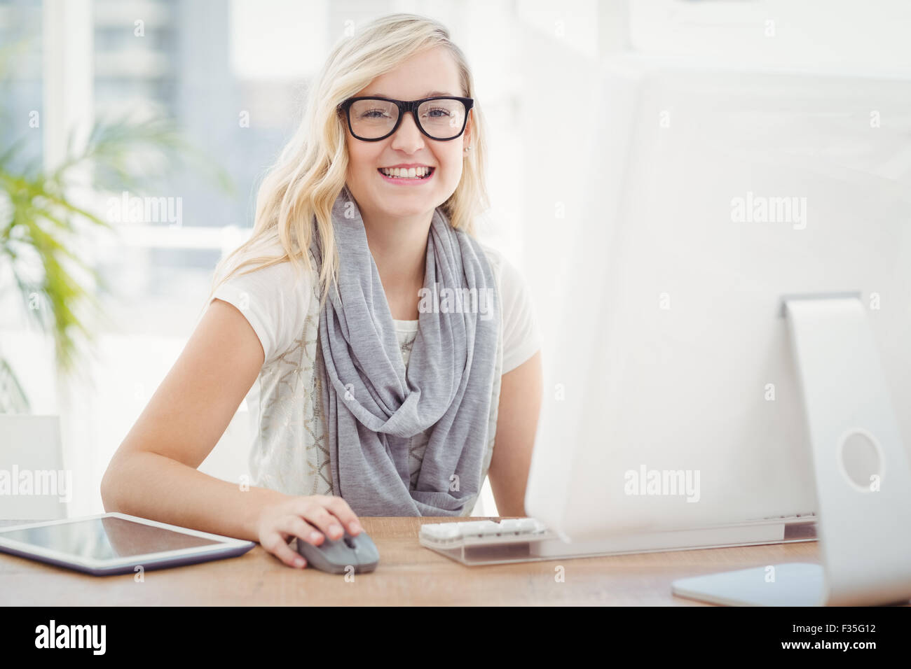 Portrait of smiling woman using computer Stock Photo - Alamy