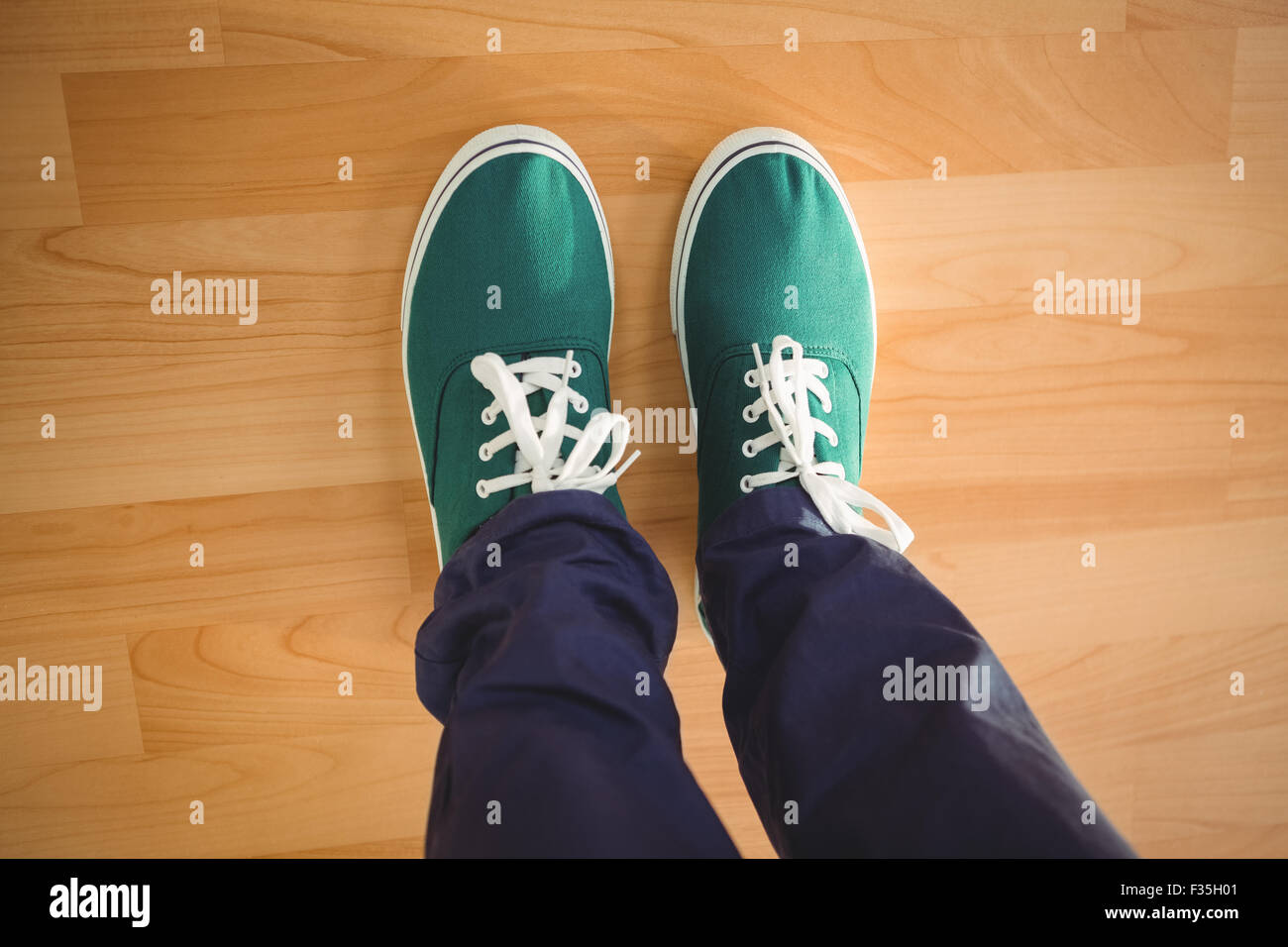 Creative businessman standing on hardwood floor Stock Photo