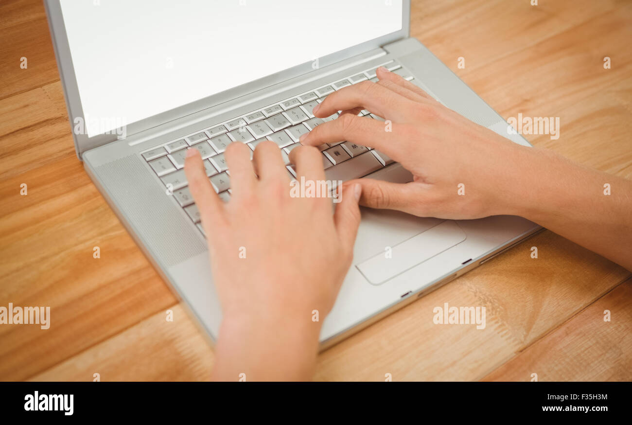Man typing on laptop at desk in office Stock Photo