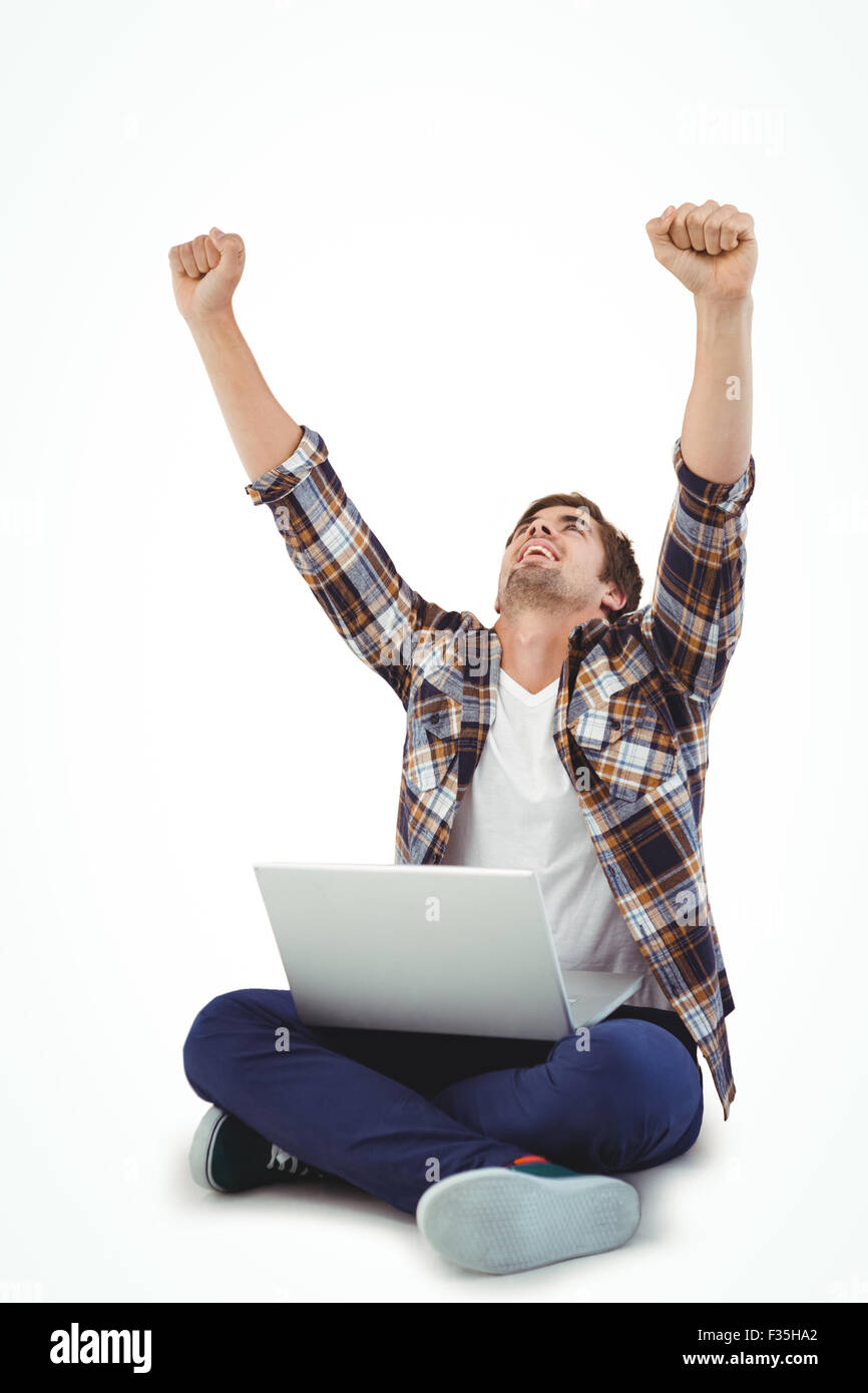 Hipster with laptop on lap cheering with arms raised Stock Photo - Alamy
