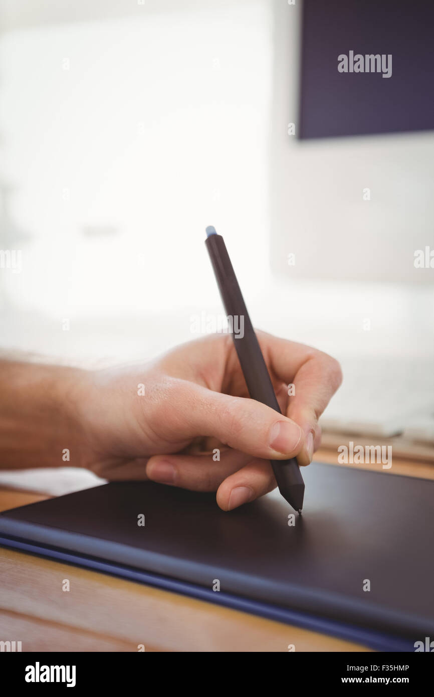 Cropped hand of man using graphics tablet Stock Photo - Alamy