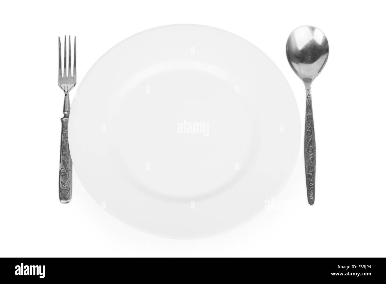 empty white plate, fork and spoon isolated on white background Stock Photo
