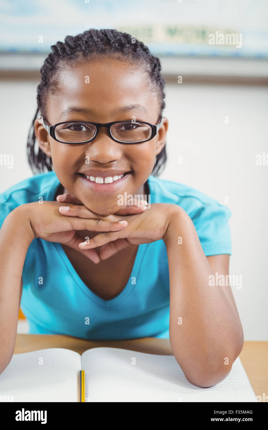 Cute pupil sitting at her desk in a classroom Stock Photo - Alamy