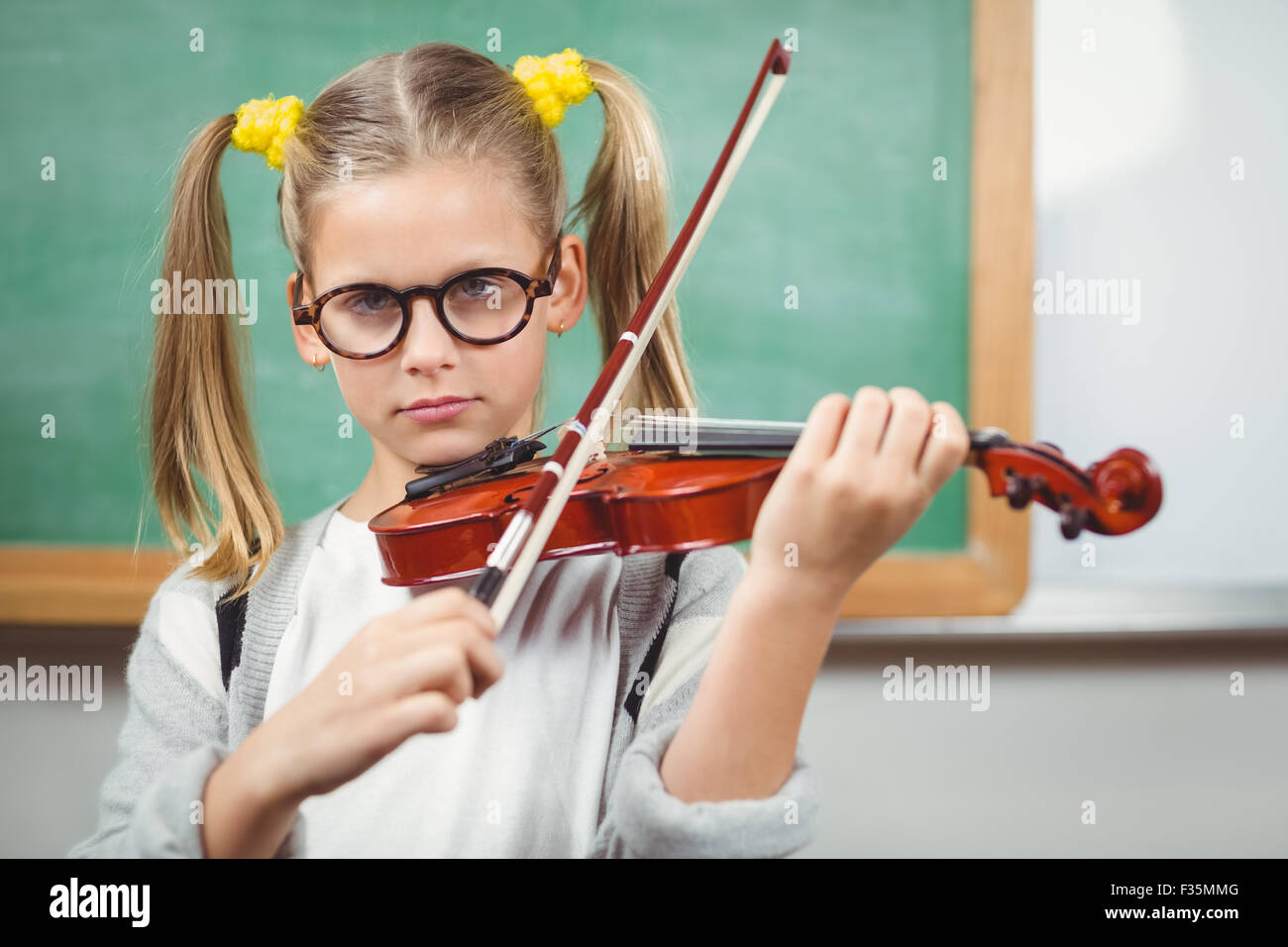 Cute pupil playing violin in a classroom Stock Photo - Alamy