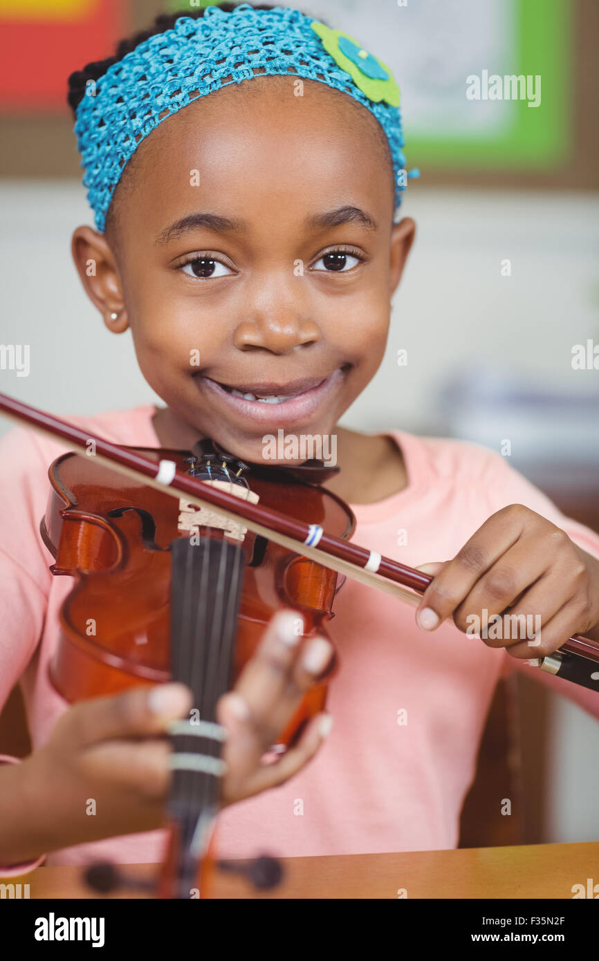 Smiling pupil playing violin in a classroom Stock Photo - Alamy