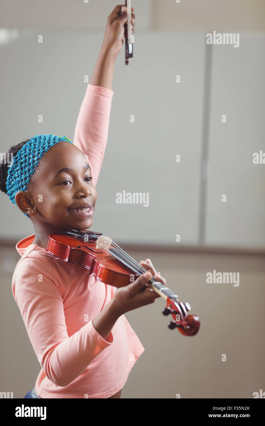 Smiling pupil playing violin in a classroom Stock Photo - Alamy
