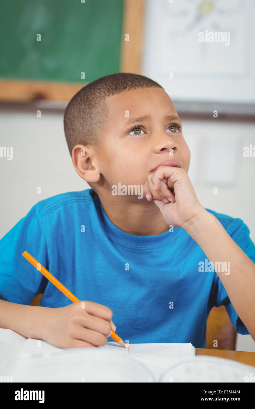 Concentrated pupil working at his desk in a classroom Stock Photo Alamy