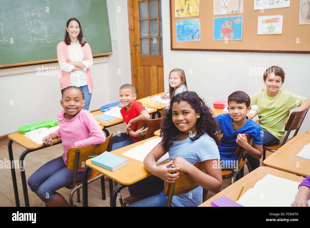 Students and teacher looking at the camera Stock Photo - Alamy