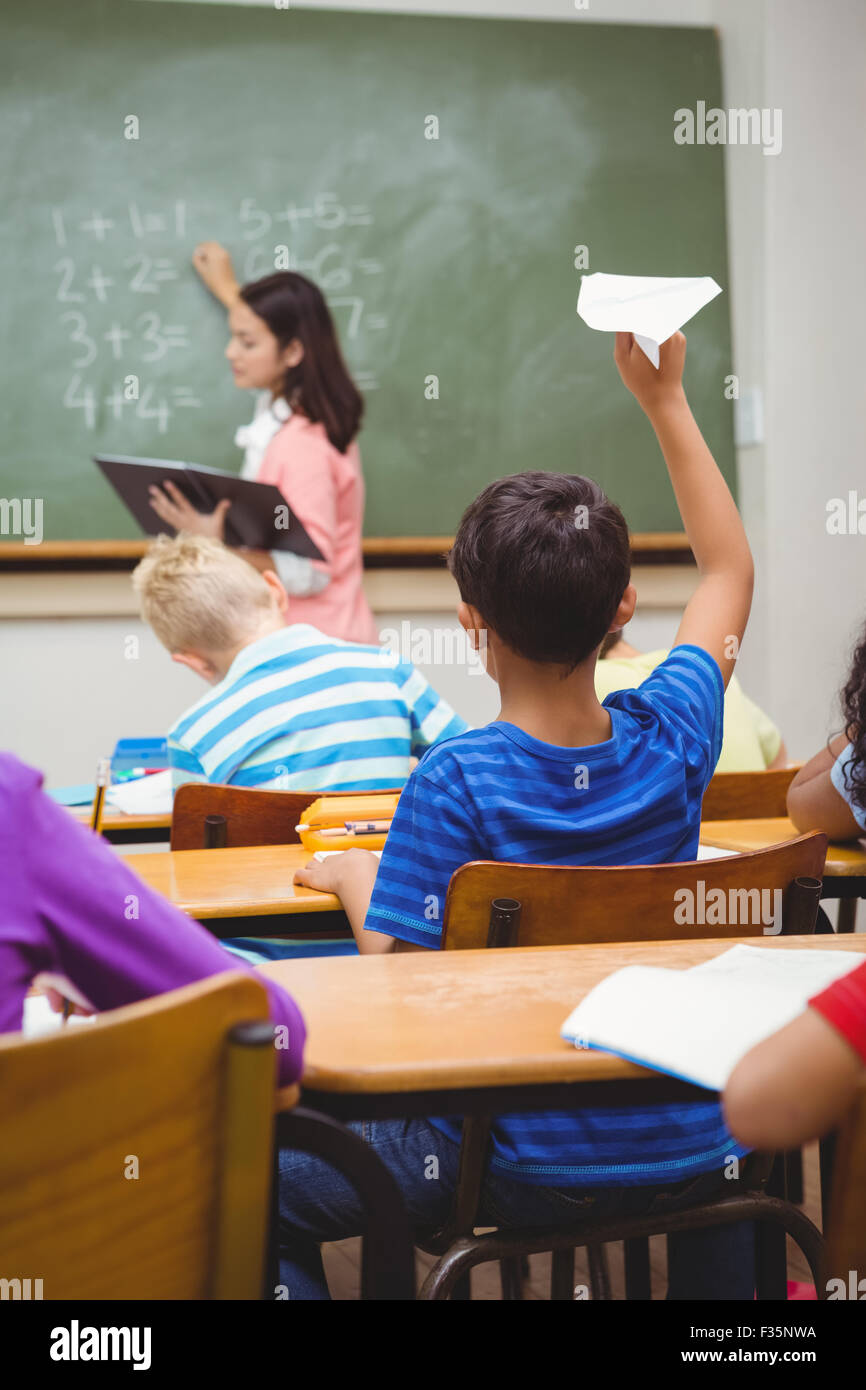 Student about to throw a paper airplane Stock Photo Alamy