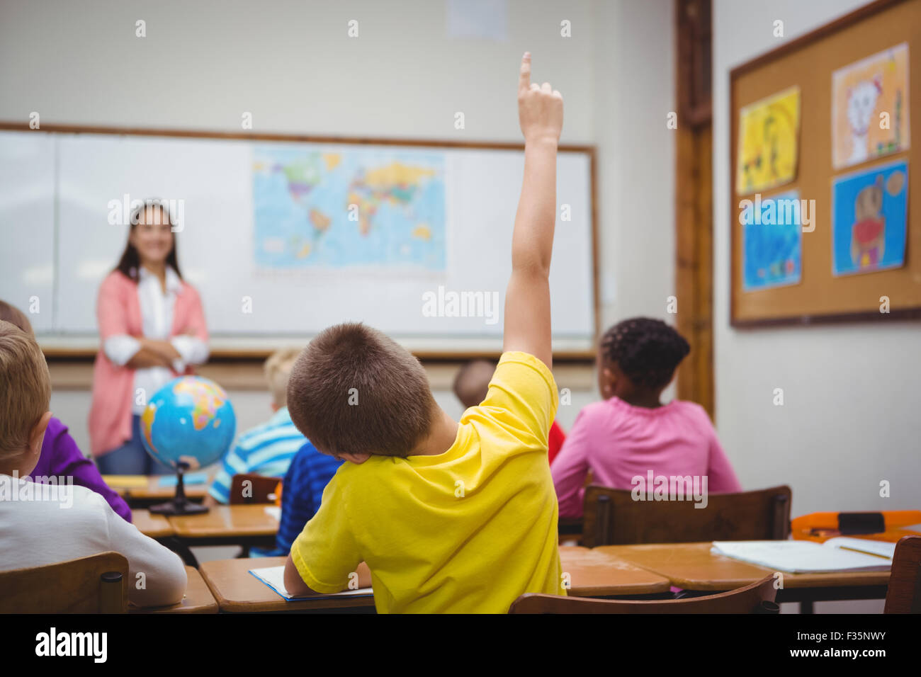 Student raising hand to ask a question Stock Photo