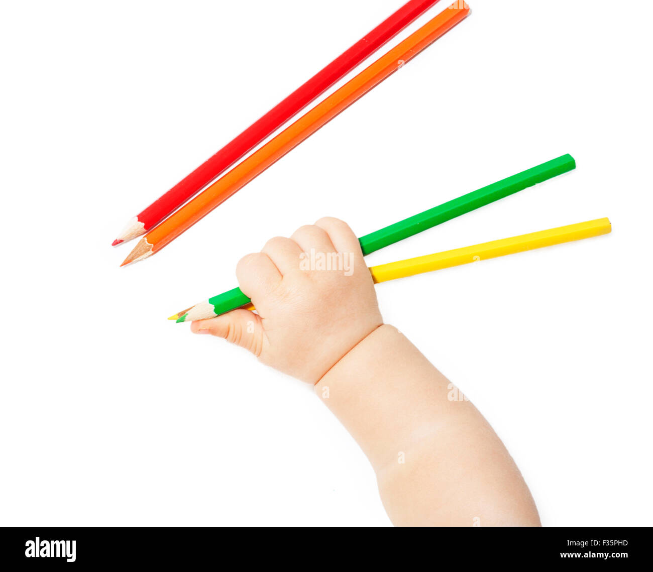 children's hand holds colour pencils isolated on white background Stock Photo