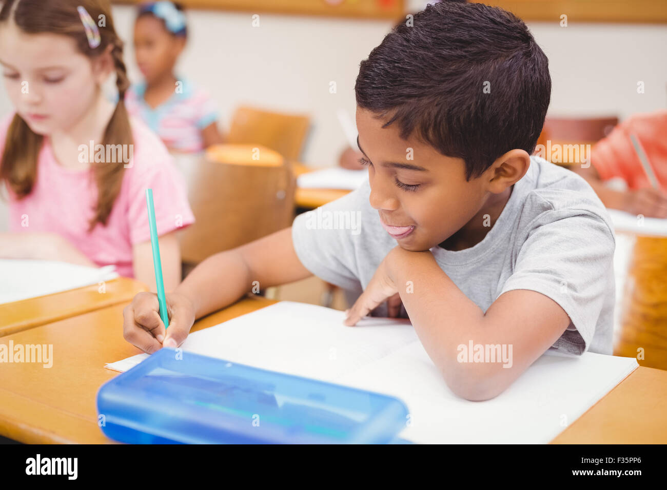 Pupil working at his desk Stock Photo - Alamy