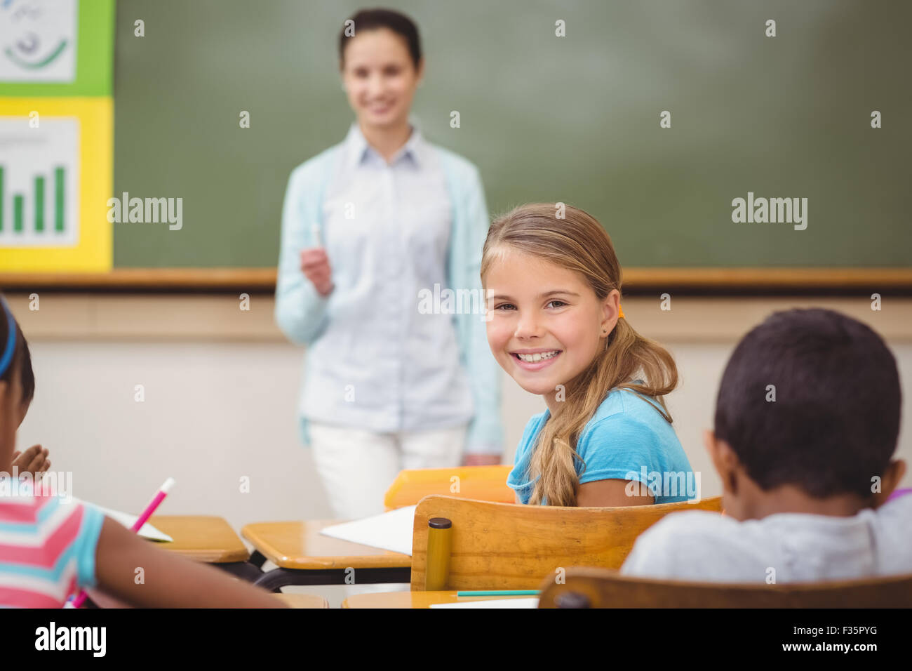 Pupil smiling at camera during class Stock Photo - Alamy