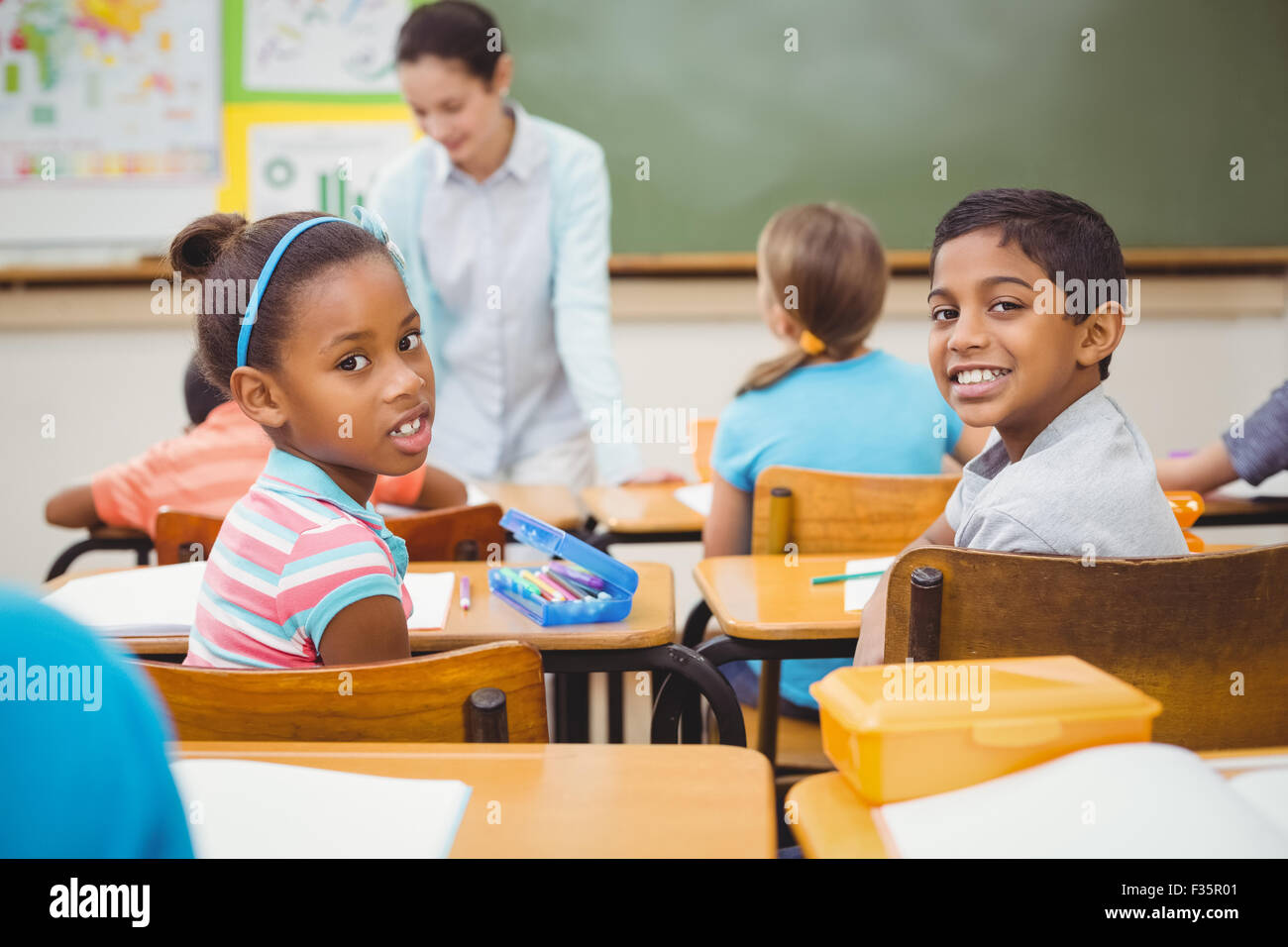 Pupils smiling at camera during class Stock Photo - Alamy