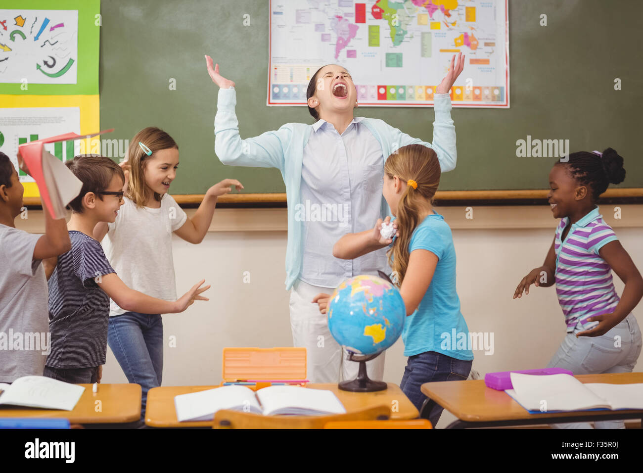 Pupils running wild in classroom Stock Photo