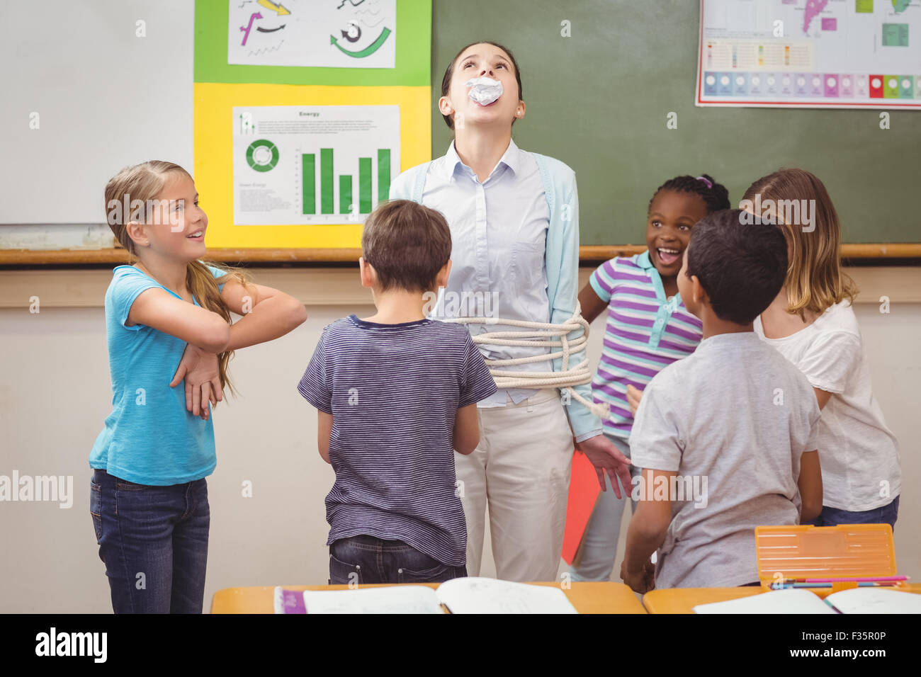 Pupils running wild in classroom Stock Photo