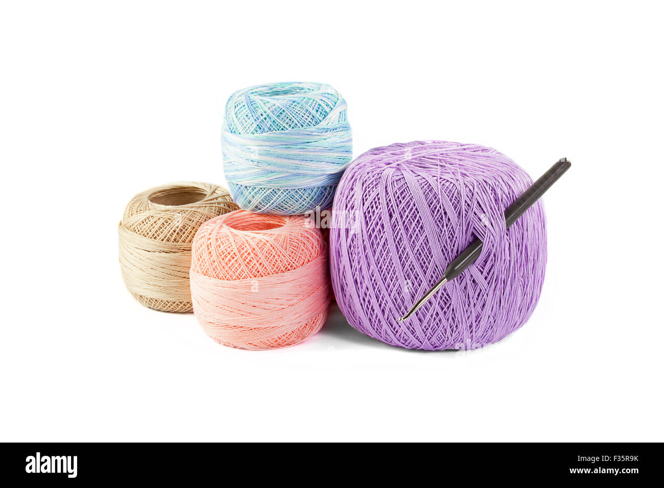 four skeins of yarn and hook isolated on white background Stock Photo ...