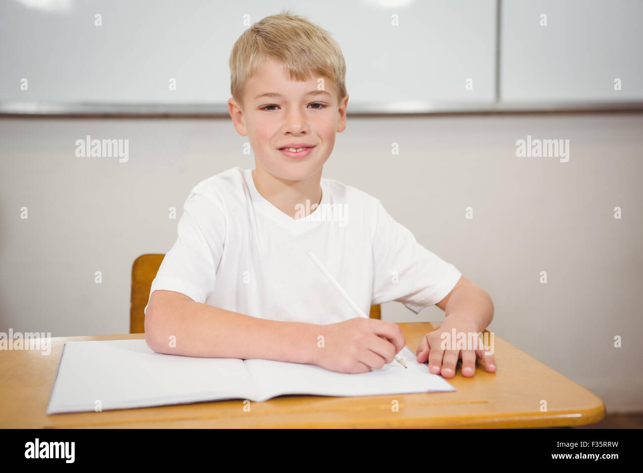 Pupil sitting at a school desk Stock Photo - Alamy