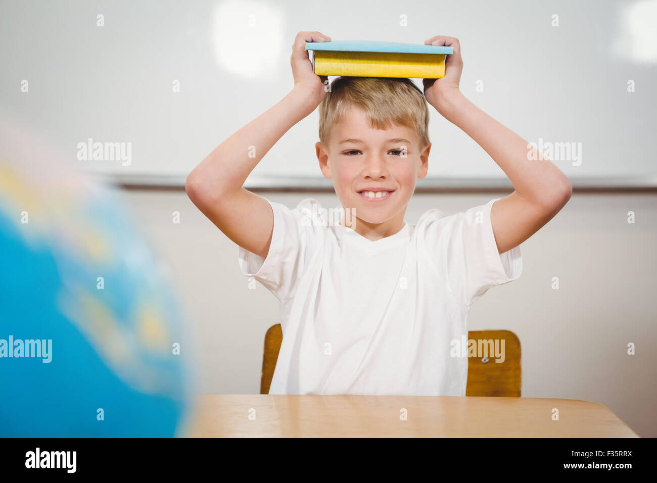 Boy holding book over head hi-res stock photography and images - Alamy