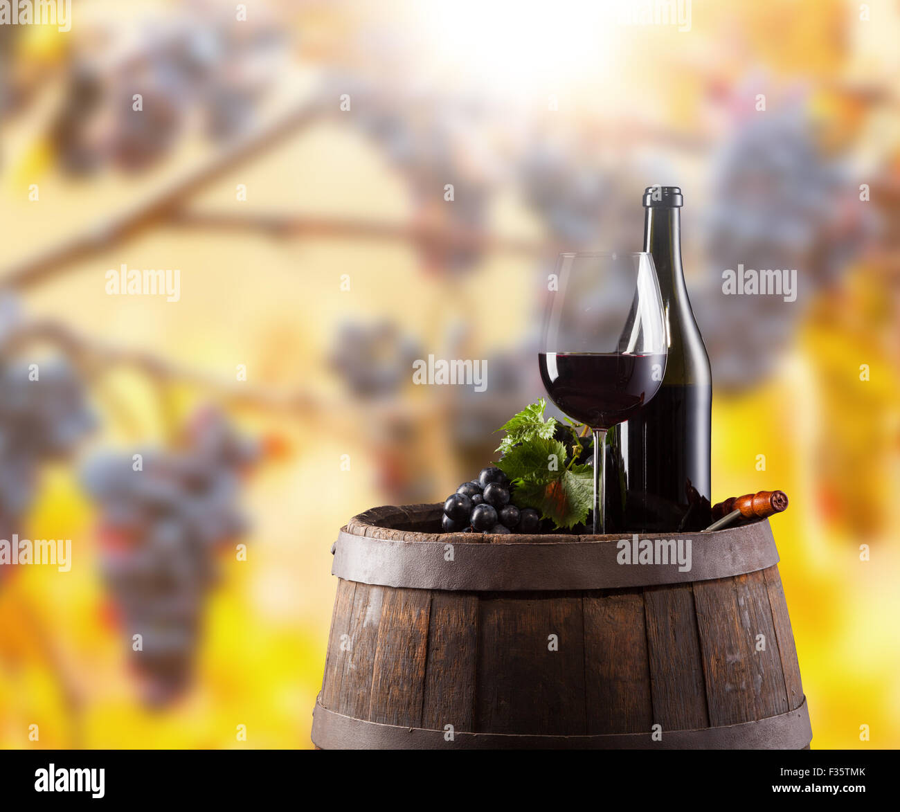 Red wine bottle and glass on wodden keg Stock Photo Alamy