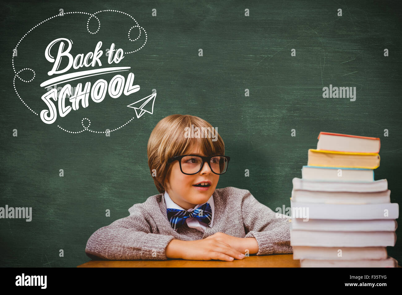 Composite image of cute pupil with pile of books Stock Photo - Alamy