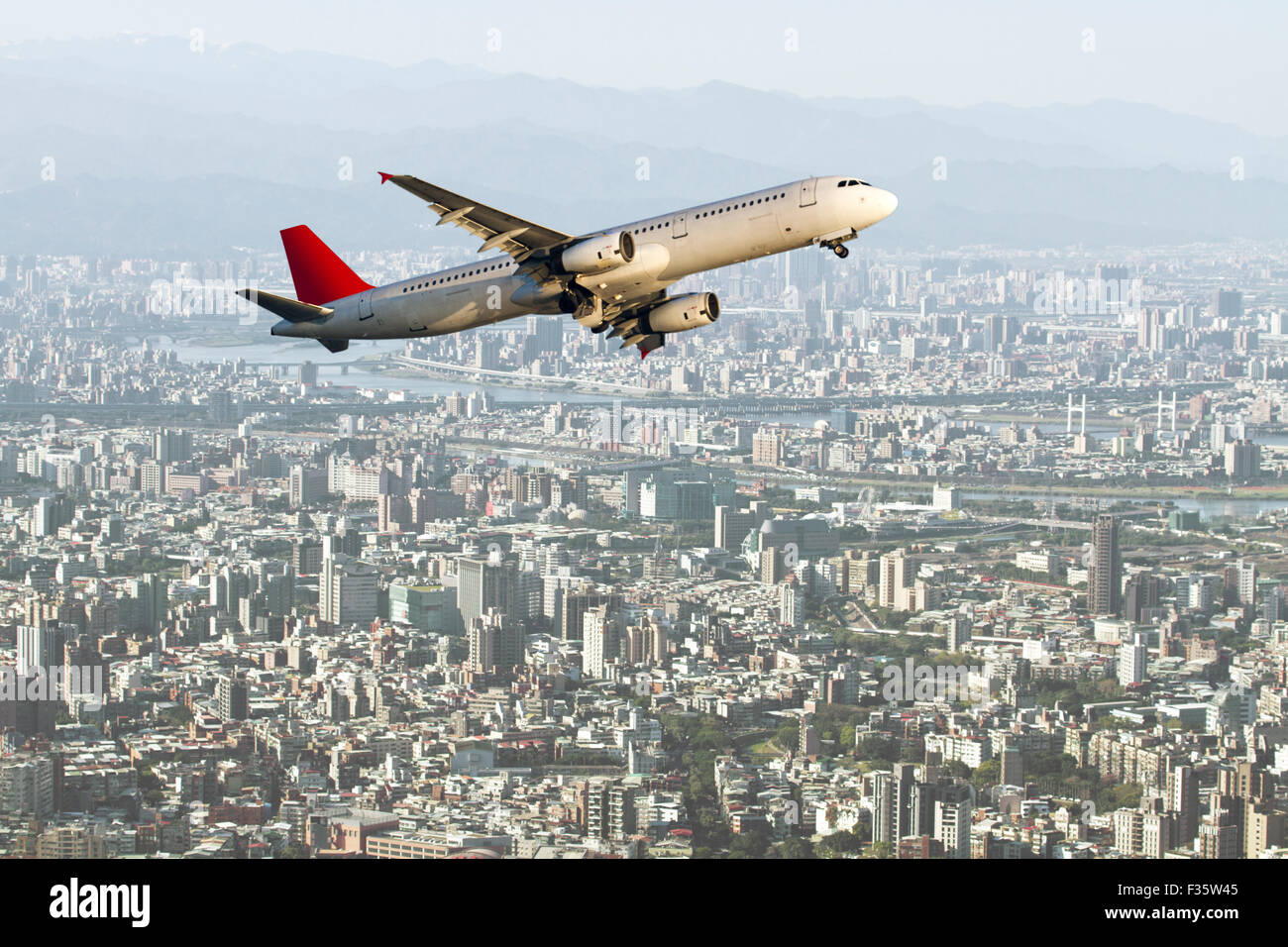 airplane fly through tiaipei city,Business Travel Stock Photo