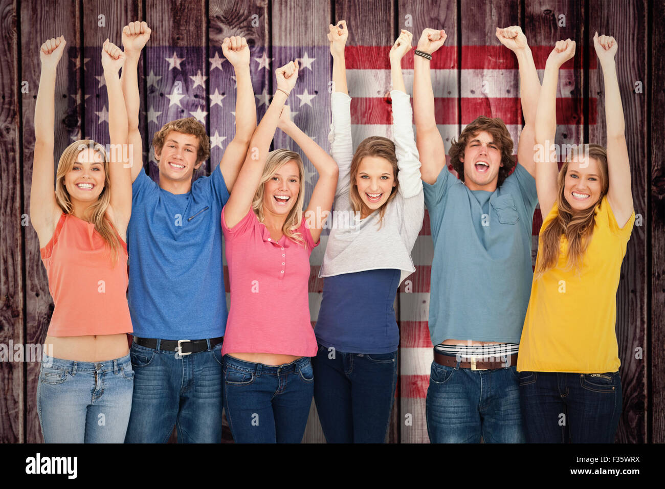 Composite image of smiling people raising hands up in the air Stock ...