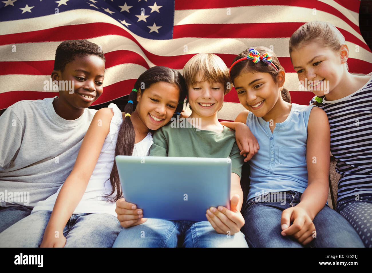 Composite image of happy children using digital tablet at park Stock ...