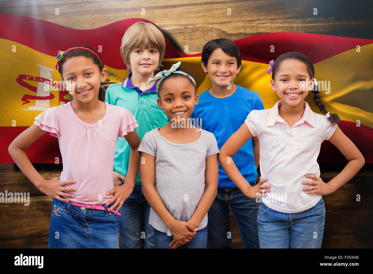 Composite image of cute pupils smiling at camera in classroom Stock ...