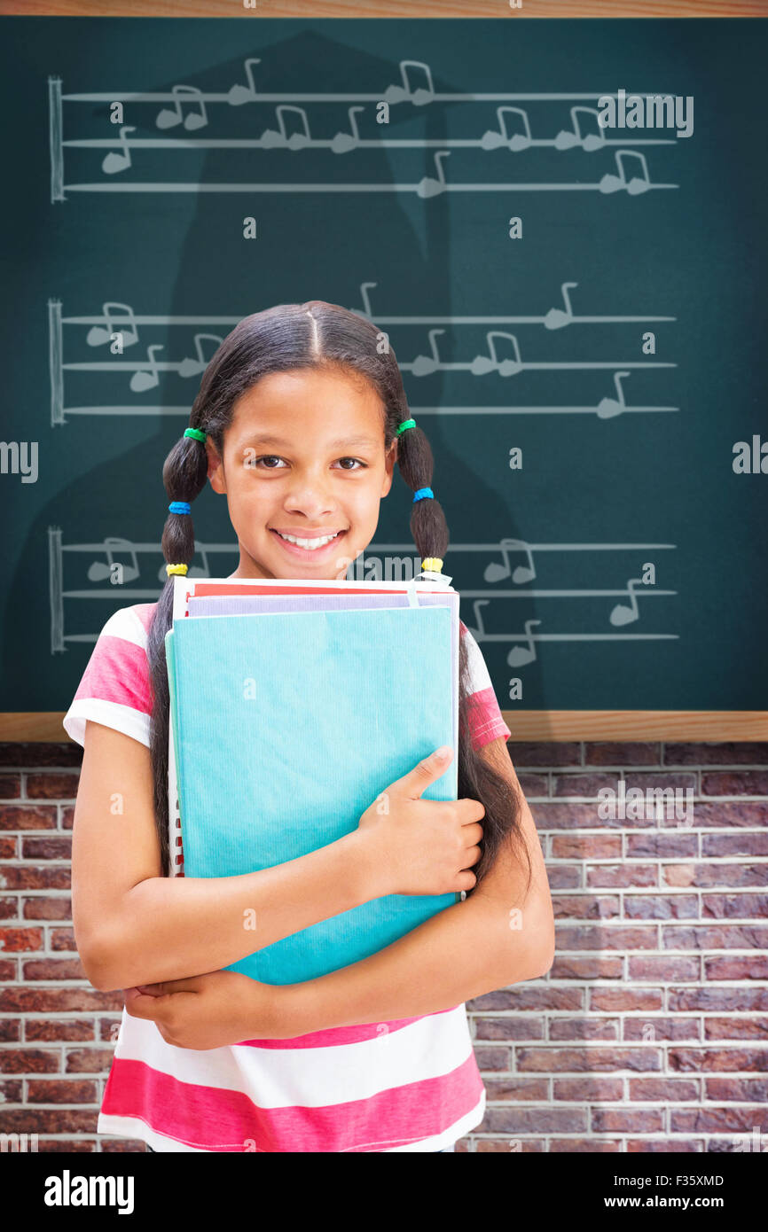 Composite image of cute pupil smiling at camera in library Stock Photo ...