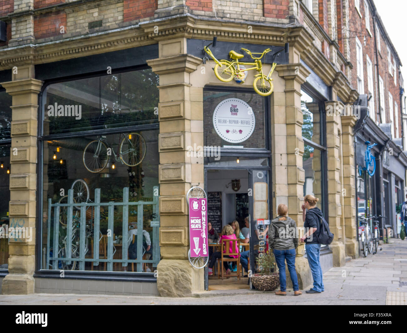 People reading the menu of a bicycle cafe in York Stock Photo