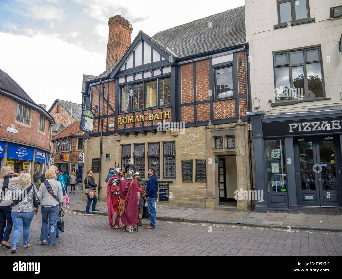 Roman soldiers outside a public house called Roman Bath in York Stock